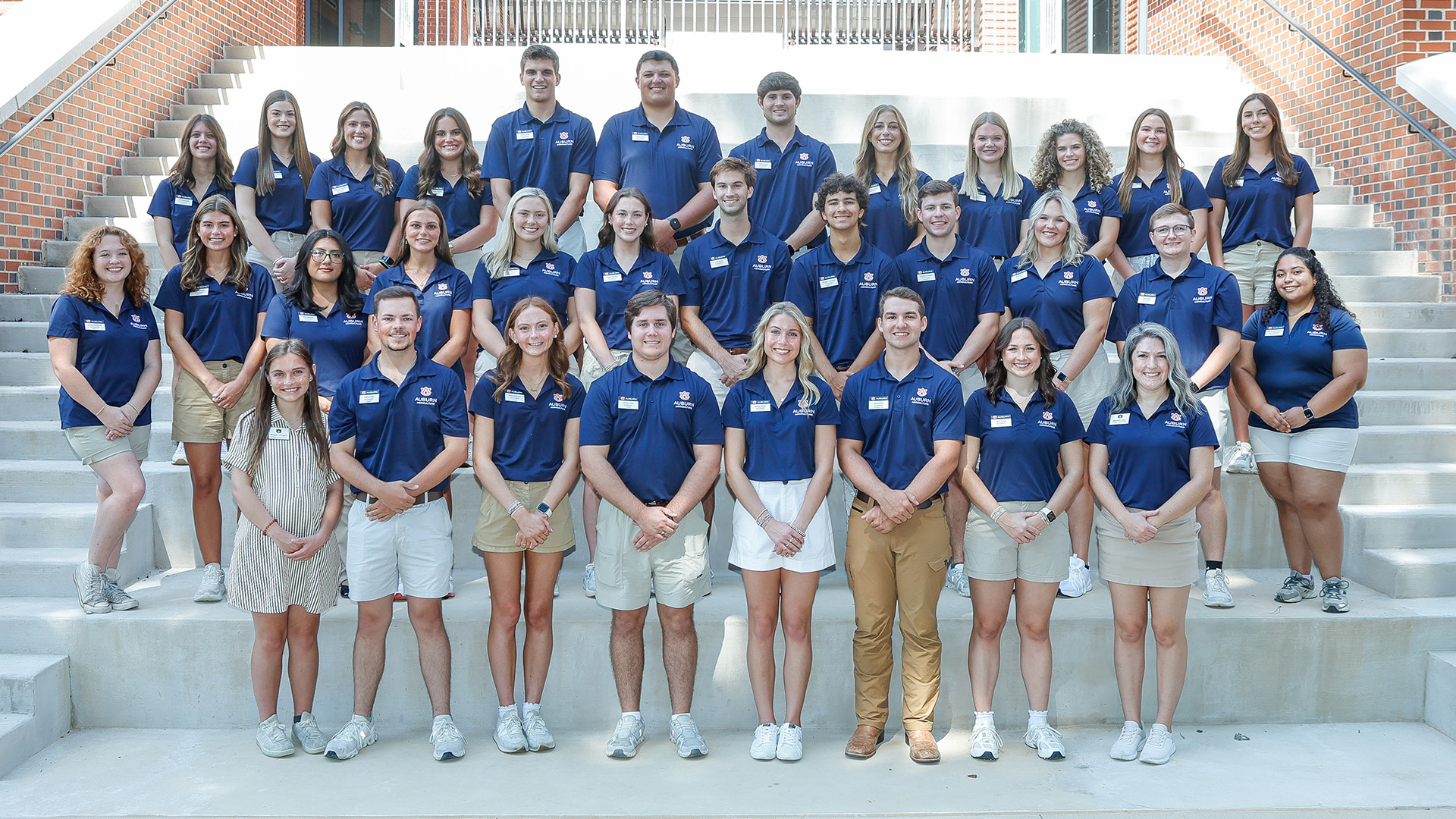 Group photo of the 2026-27 Ag Ambassadors and advisor standing on steps of a building on the Auburn University campus