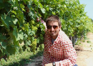 Photo of student Andrej Svyantek collects data from European grapes growing at the Chilton Research and Extension Center.
