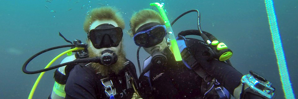 Scuba-Divers-AU-Marine-Fish-Lab-sm One male and female scuba divers pose underwater while doing fish research in the Gulf of Mexico.