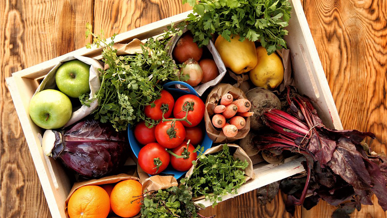 Crate of fresh, groceries, fruit, vegetables Food on a wood kitchen table