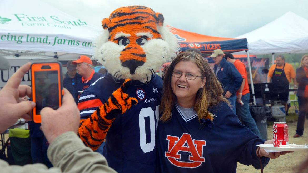 Auburn's Aubie taking a picture with Auburn fan at Ag Roundup