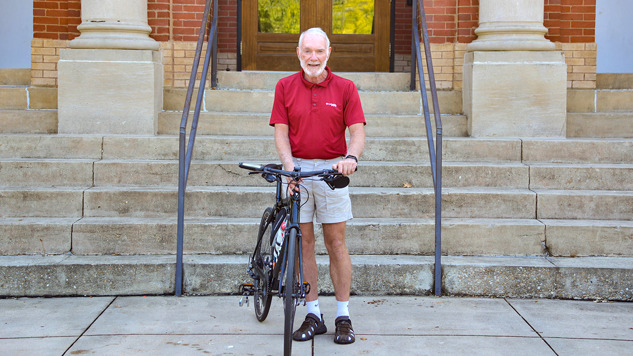 Raymond Kessler poses with his bike after surviving a hit-and-run cycling accident in Auburn, AL