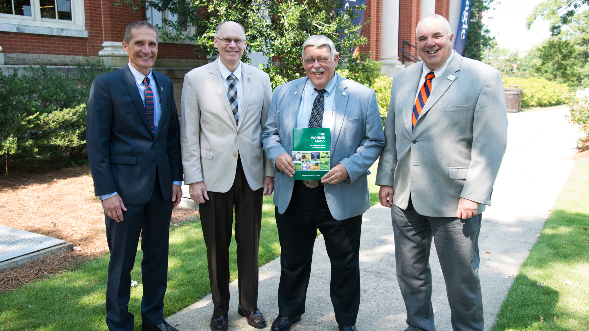 Don Ball, author of book, The Wonder Grass, with Dr. Beasley, Paul Patterson, Gary Lemme in front of Comer Hall, Auburn, AL
