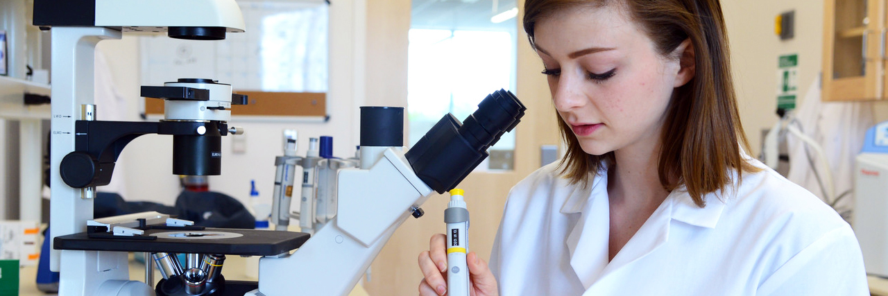 Student in Research Lab and microscope trial dna sampling