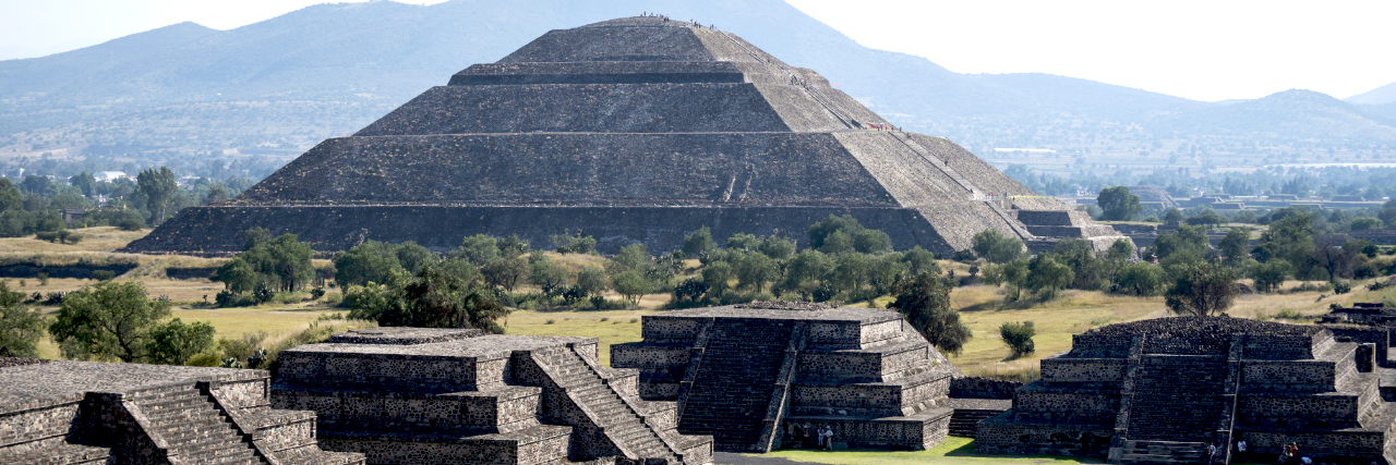 Pyramid of the Sun in Teotihuacan, Mexico Teotihuacan, Mexico - October 29, 2014: View from the Pyramid of the Moon of people visiting Teotihuacan, Mexico. The large pyramid is the Pyramid of the Sun.