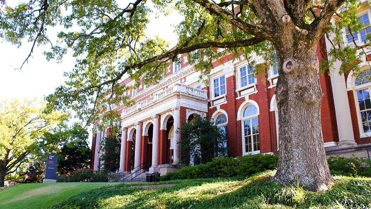 Comer Hall, Auburn University College of Agriculture, Alabama, USA, visiting campus on a sunny afternoon under an oak tree.