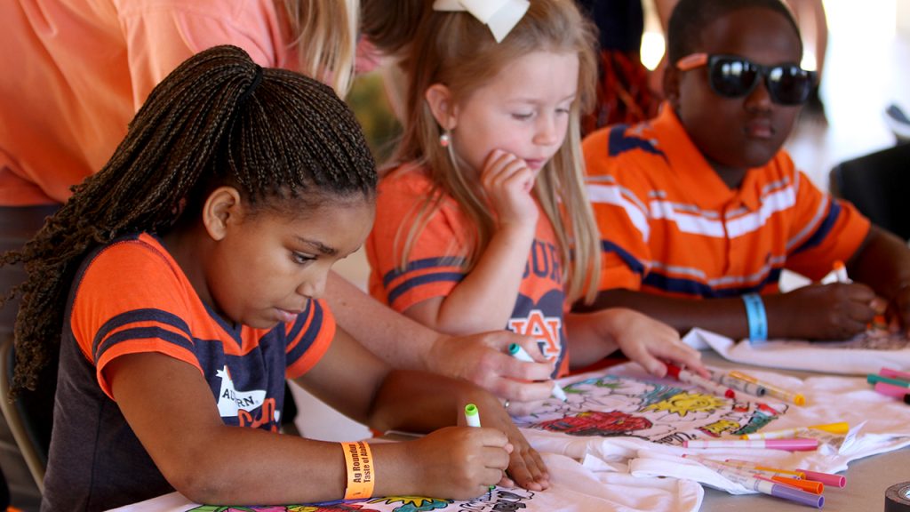 Ag Roundup, Auburn, AL Event, kids coloring T-shirts with markers at Ag Heritage Park