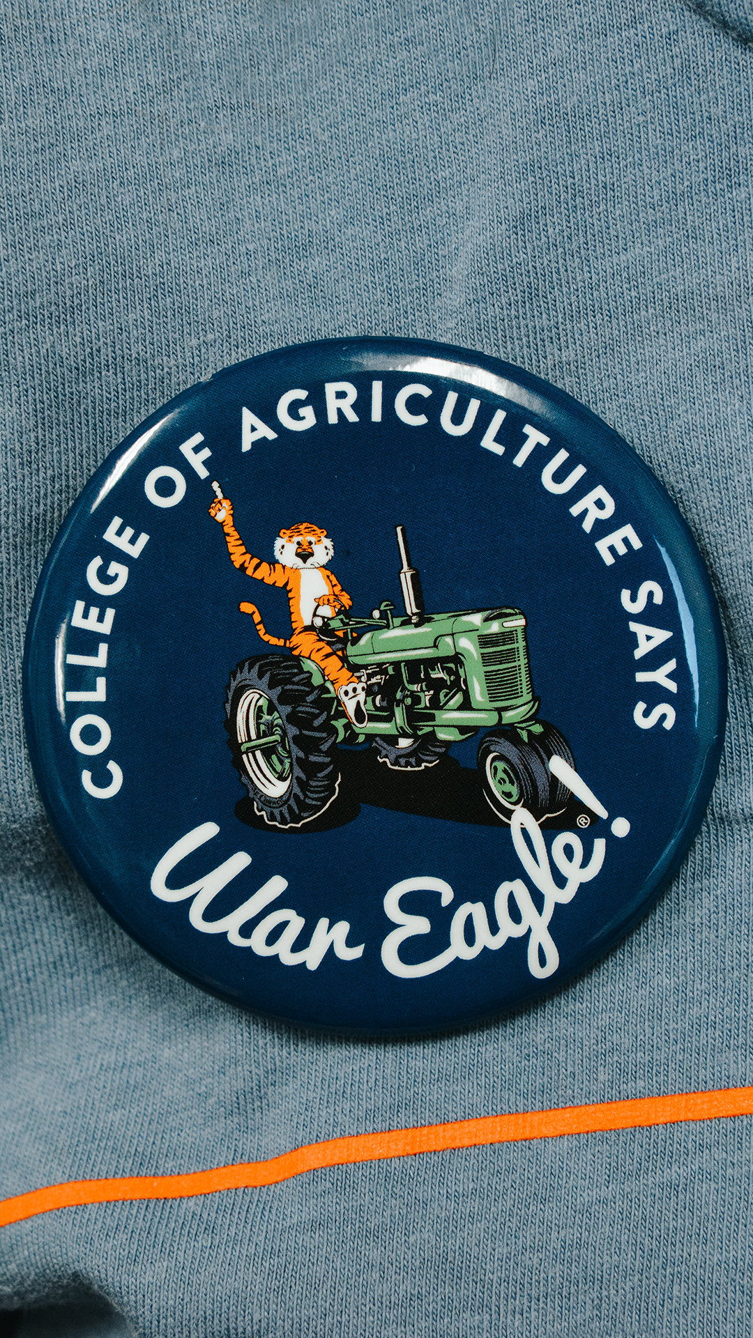 Auburn College of Agriculture Says War Eagle! Game Day Button, Aubie the tiger on a tractor