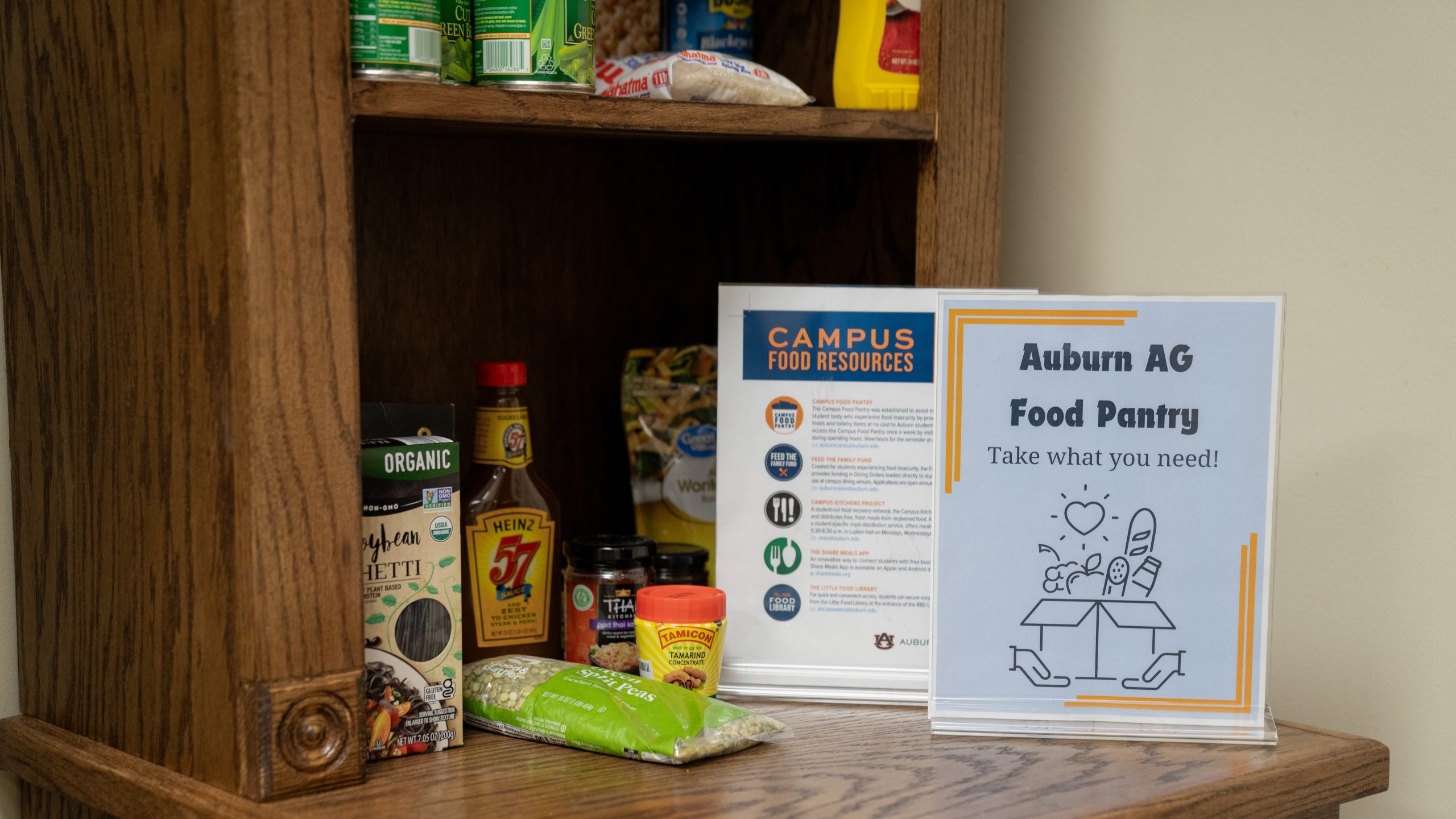 food pantry shelves hold packaged food and signage